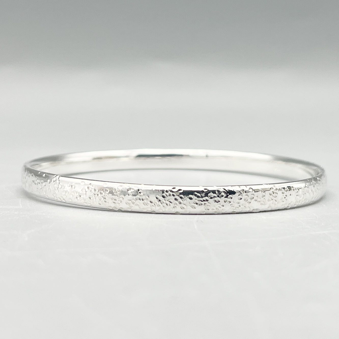Sterling Silver Bangle. 'Star hammered' finish 70mm x 5.4mm x 2.3mm