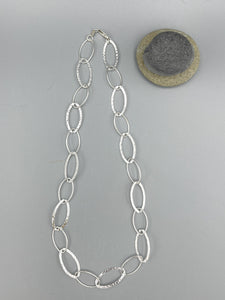 Sterling Silver Necklace. 21” long comprising alternate polished and hammered rings ring necklace
