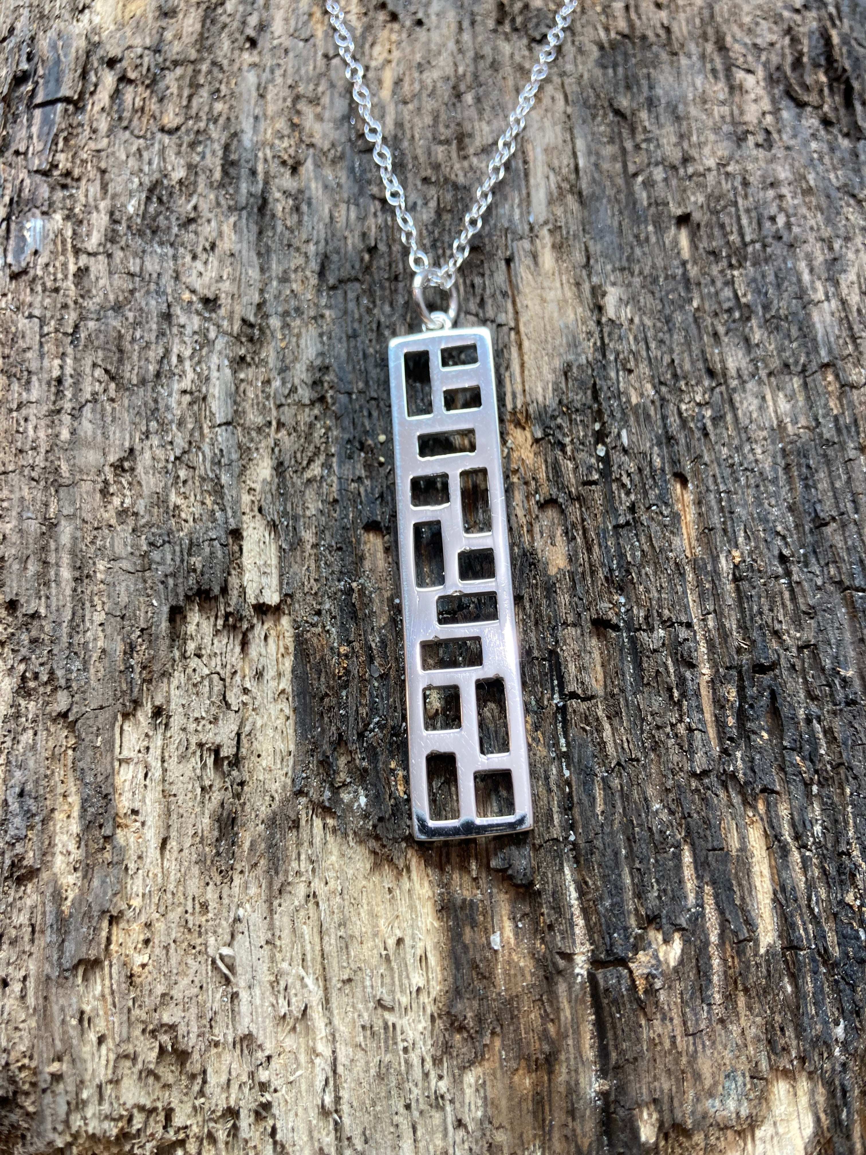 Sterling Silver polished geometric rectangular pendant on 16" trace chain