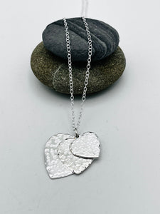 Triple heart pendant hammered finish on 16" trace chain