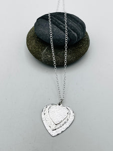 Triple heart pendant hammered finish on 16" trace chain