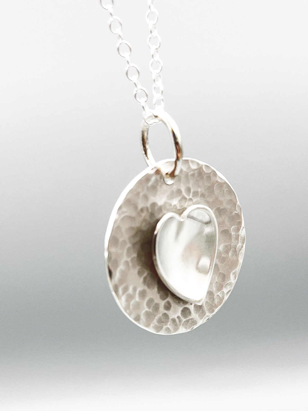 Sterling Silver pendant. A polished heart on a hammered disc on a 16" chain