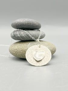 Sterling Silver pendant. A polished heart on a hammered disc on a 16" chain